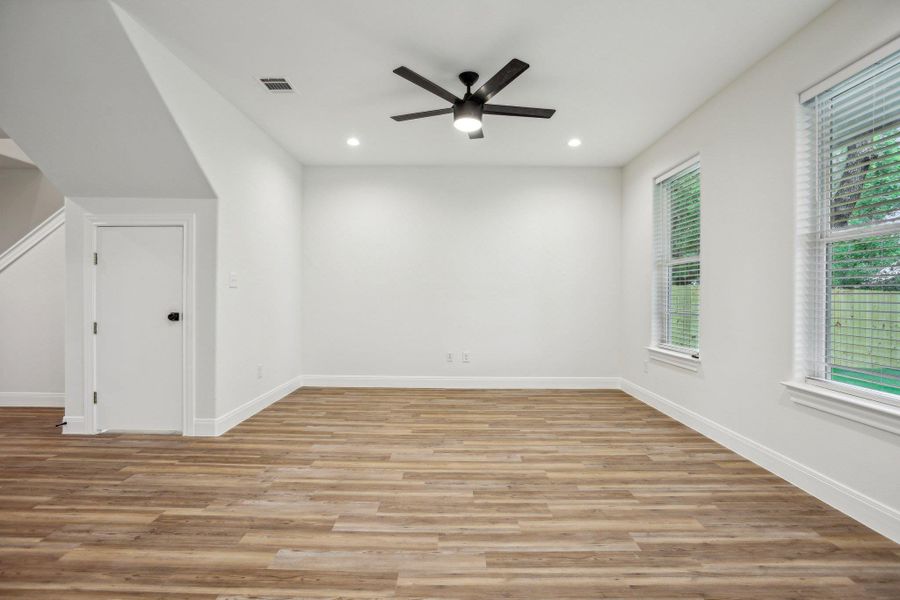 Living room with ceiling fan, recessed lighting, visible vents, and vinyl wood plank floors