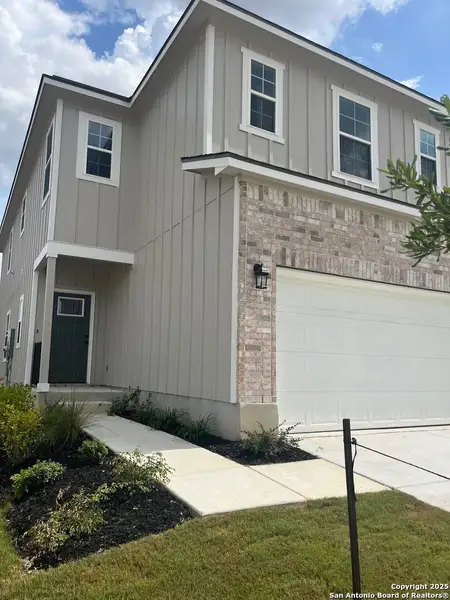 Front exterior of a new home in Highland Ridge, New Braunfels, TX, highlighting curb appeal (Image 1).