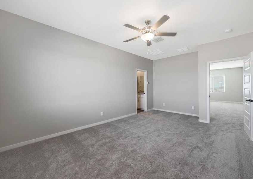 Expansive master bedroom with an attached bathroom.