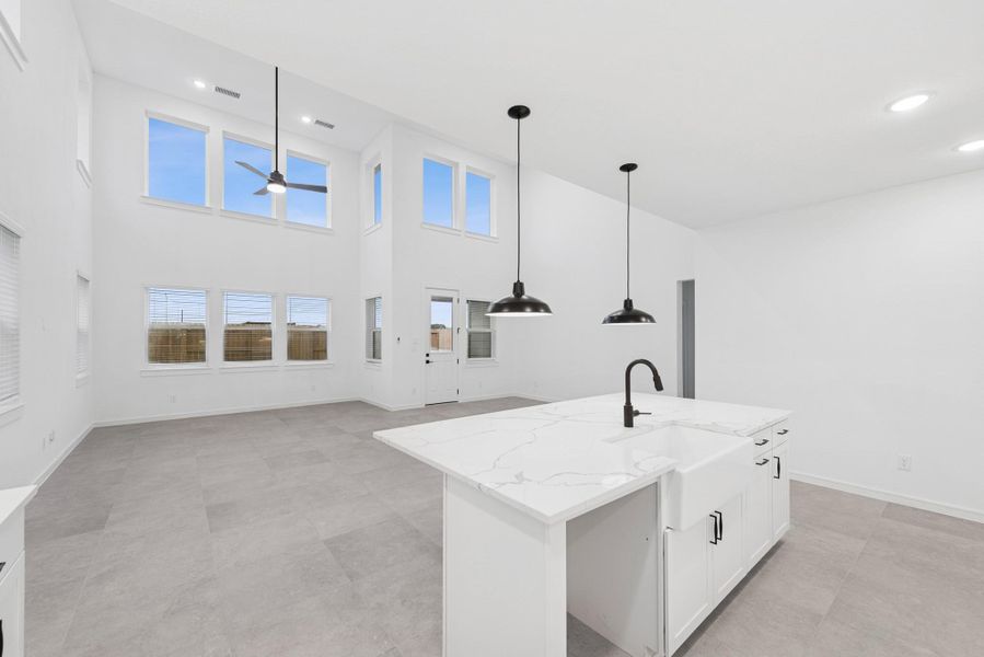 Kitchen overlooks great room and dining area