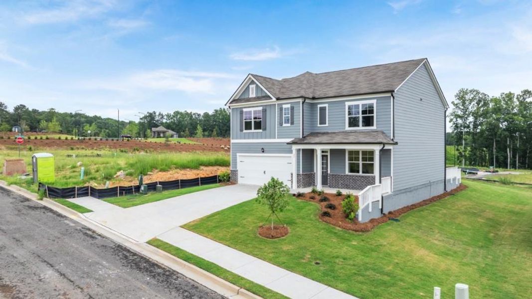 Front exterior of a new home in Sheffield Highlands, Dallas, GA, highlighting curb appeal (Image 1). Front exterior of a new home in Sheffield Highlands, Dallas, GA, highlighting curb appeal (Image 1).