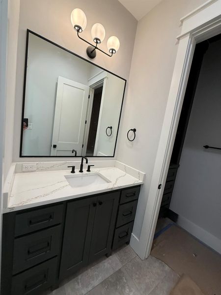 Bathroom featuring vanity and baseboards
