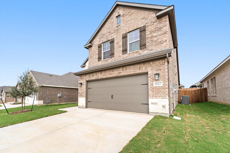 Front exterior of a new home in Liberty Pointe, Gainesville, TX, highlighting curb appeal (Image 21). Front exterior of a new home in Liberty Pointe, Gainesville, TX, highlighting curb appeal (Image 21).