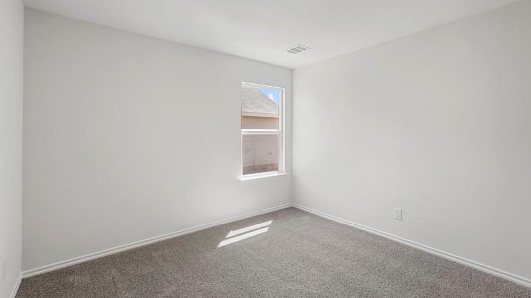 Room featuring light gray walls, gray carpet flooring, and a single window