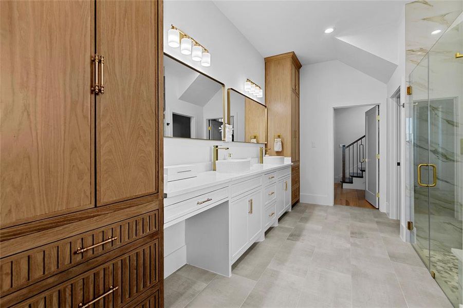 Bathroom featuring vanity, vaulted ceiling, a marble finish shower, and recessed lighting Bathroom featuring vanity, vaulted ceiling, a marble finish shower, and recessed lighting