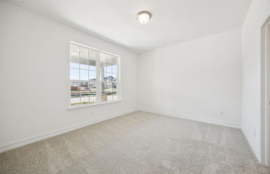 Spacious secondary bedroom with large windows