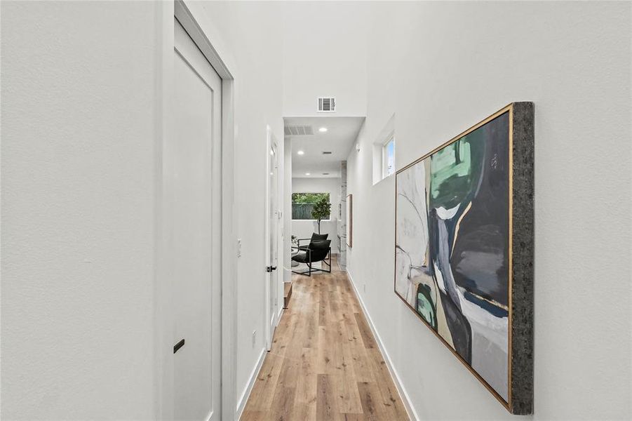 Hall with light hardwood / wood-style flooring