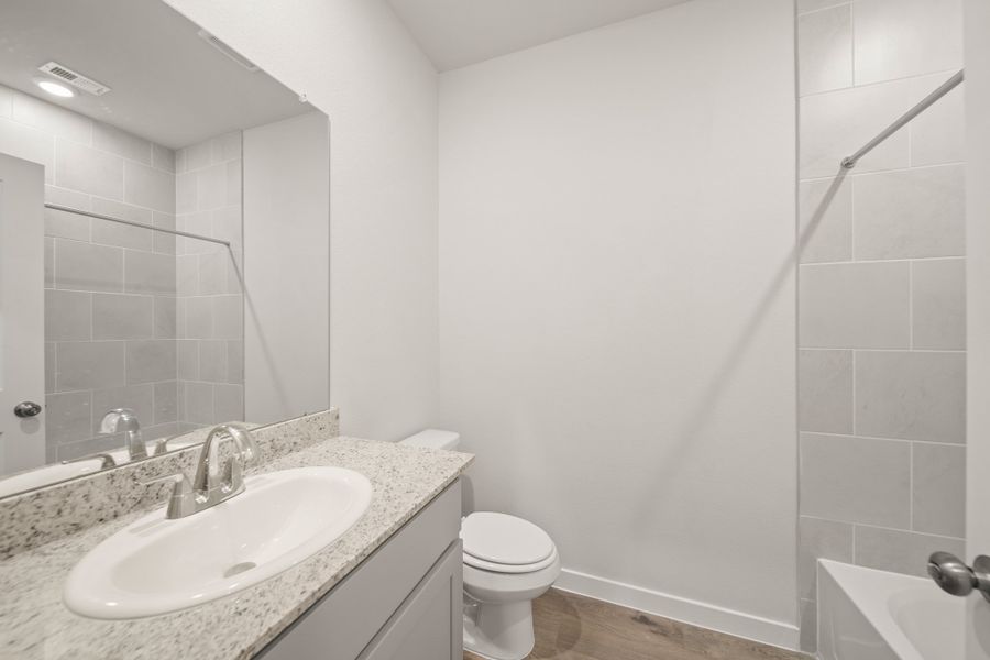 A bathroom with a sink and a toilet.