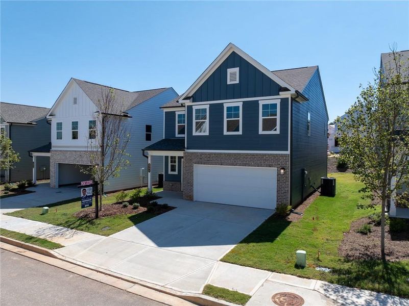 Front exterior of a new home in Annsbury Park, Lilburn, GA, highlighting curb appeal (Image 2). Front exterior of a new home in Annsbury Park, Lilburn, GA, highlighting curb appeal (Image 2).