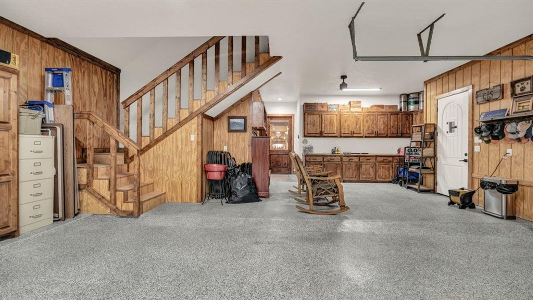 Additional perspective showcasing stair access, cabinetry, and workbench area.