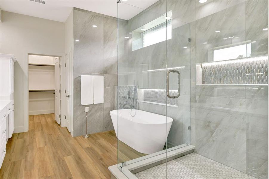Glass-enclosed shower with honeycomb tile flooring and integrated shelf lighting Glass-enclosed shower with honeycomb tile flooring and integrated shelf lighting