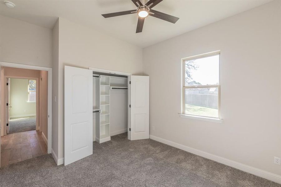Unfurnished bedroom featuring carpet, a closet, and ceiling fan Unfurnished bedroom featuring carpet, a closet, and ceiling fan