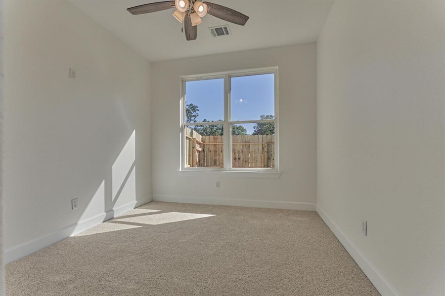 Secondary bedroom #3 features natural lighting, plush carpeting, and a ceiling fan. Secondary bedroom #3 features natural lighting, plush carpeting, and a ceiling fan.