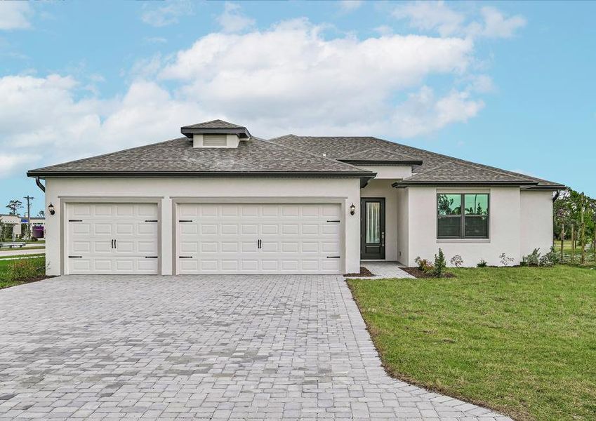 One-story home with front yard landscaping and a three-car garage.