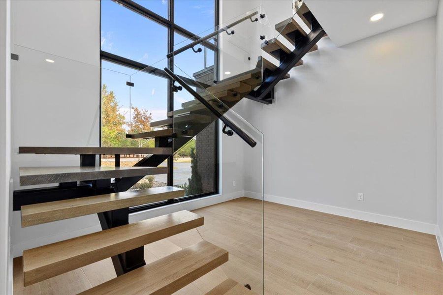 Floating Wood Staircase with glass encased railing wall. Floating Wood Staircase with glass encased railing wall.