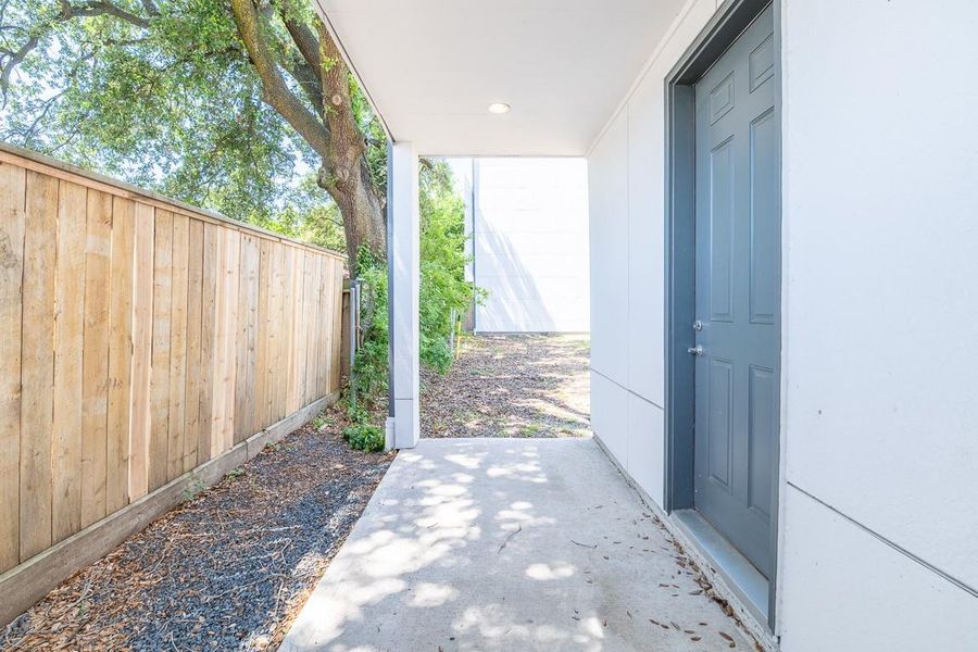 Back porch area is now fenced in and has a gate.  Nice area from the garage or the 1st floor bedroom.  Garage through the door has a flex area for a workshop/ workout area, storage, etc.