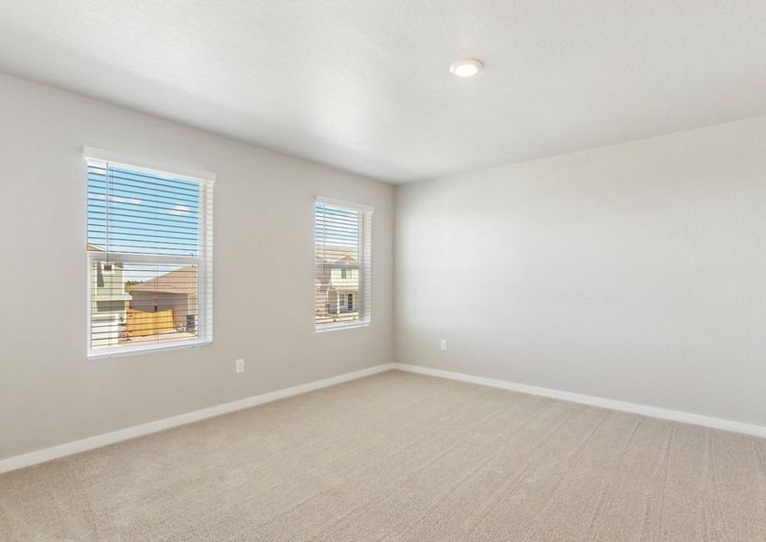 The master bedroom is spacious with two large windows.