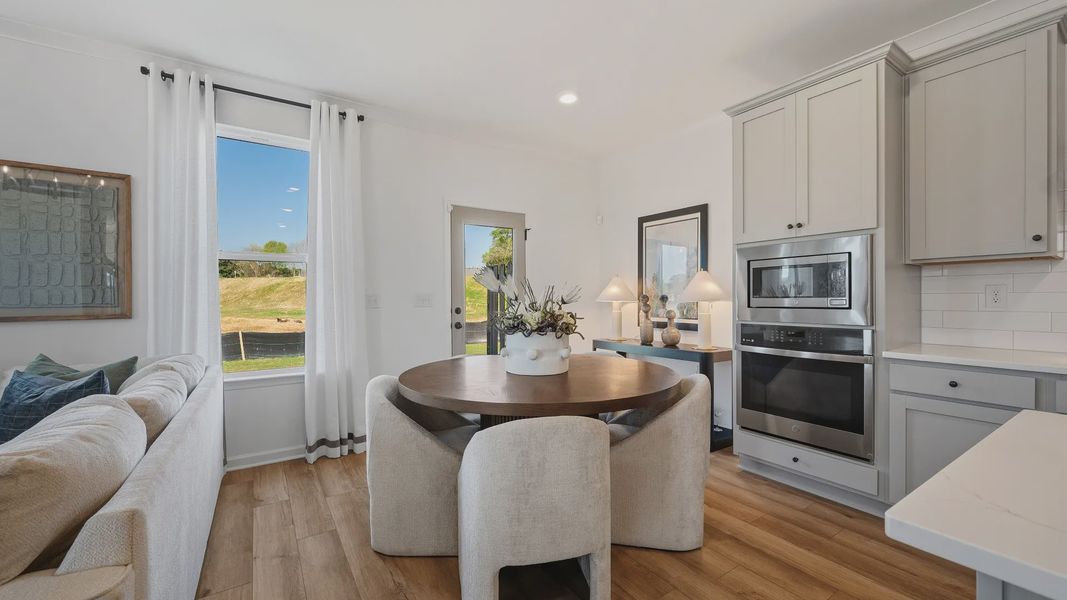 Open breakfast space with abundant natural light and seamless flow from kitchen in townhome in Loganville, GA. Open breakfast space with abundant natural light and seamless flow from kitchen in townhome in Loganville, GA.