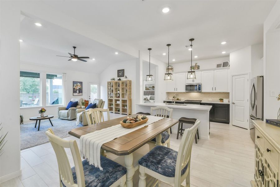 The bright and airy dining room is lit by recessed LED lighting and has space for a buffet or sideboard to store linens and dishes.