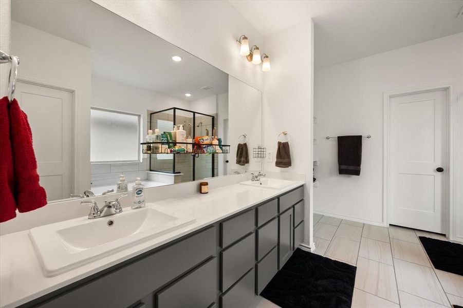 Double vanity with modern, rectangular sinks, chrome fixtures, and grey cabinetry