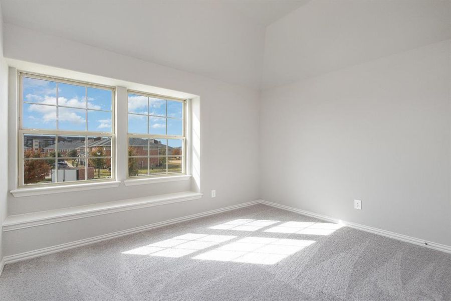 Empty room with light colored carpet