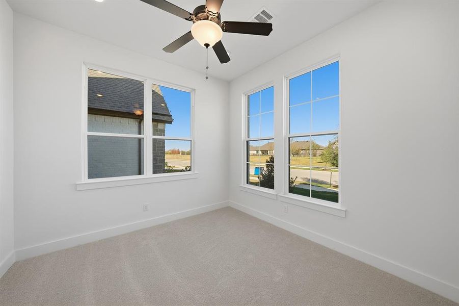 Unfurnished room with carpet flooring and a ceiling fan Unfurnished room with carpet flooring and a ceiling fan