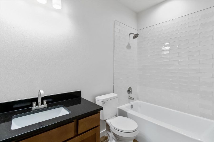 Bathroom with vanity and bathing tub / shower combination Bathroom with vanity and bathing tub / shower combination