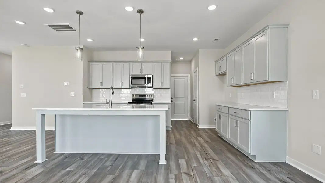 View of kitchen showcasing modern light fixtures for superb cooking and dining experiences View of kitchen showcasing modern light fixtures for superb cooking and dining experiences