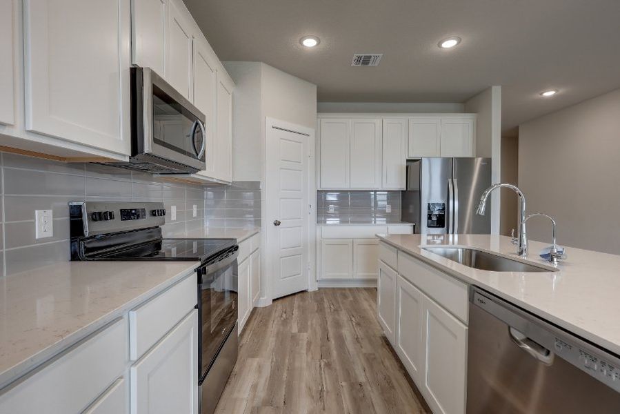 A kitchen with white cabinets. A kitchen with white cabinets.