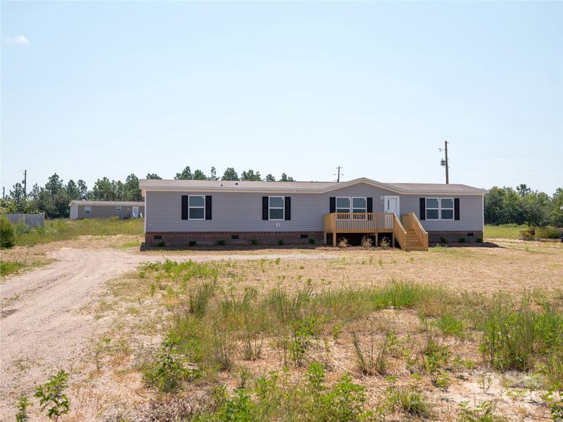Front exterior of a new home in , Mount Croghan, SC, highlighting curb appeal (Image 1).