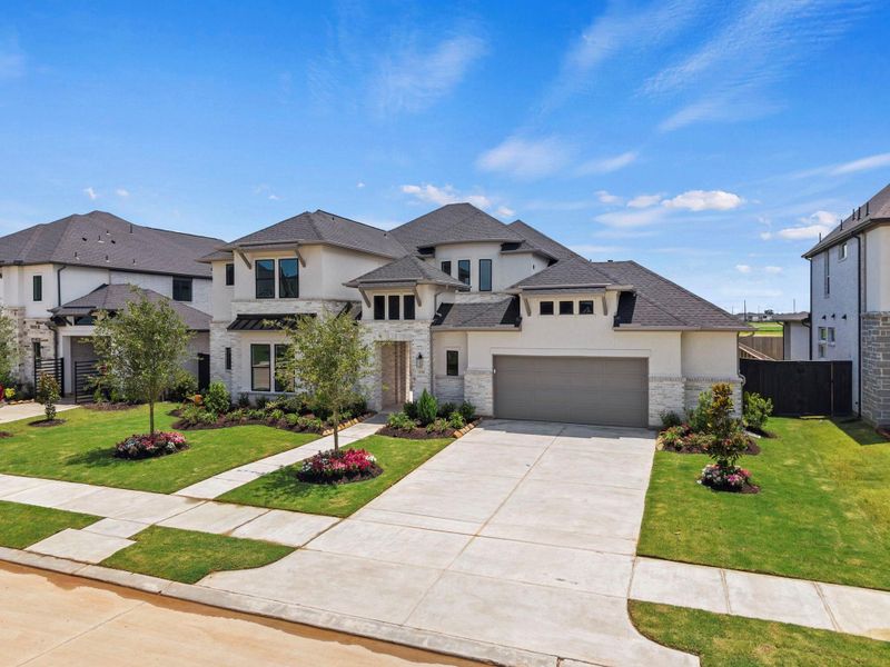 Front exterior of a new home in Harvest Green, Richmond, TX, highlighting curb appeal (Image 2). Front exterior of a new home in Harvest Green, Richmond, TX, highlighting curb appeal (Image 2).