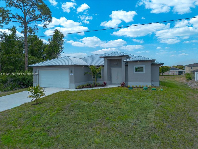 Front exterior of a new home in , Lehigh Acres, FL, highlighting curb appeal (Image 1). Front exterior of a new home in , Lehigh Acres, FL, highlighting curb appeal (Image 1).