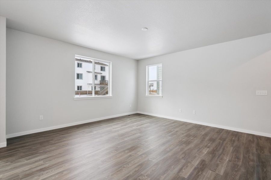 A room with a wood floor and a window.
