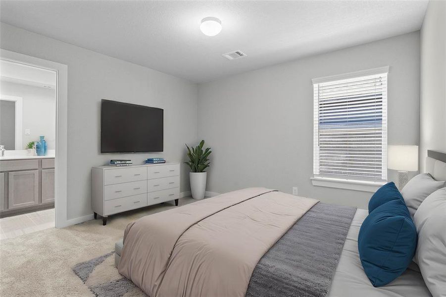 Secondary bedroom features plush carpet, neutral paint, large window with privacy blinds, and access to its own private secondary bathroom.