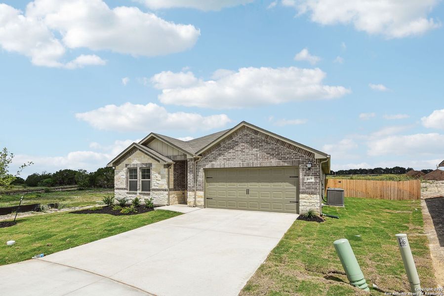 Front exterior of a new home in , Cibolo, TX, highlighting curb appeal (Image 1). Front exterior of a new home in , Cibolo, TX, highlighting curb appeal (Image 1).