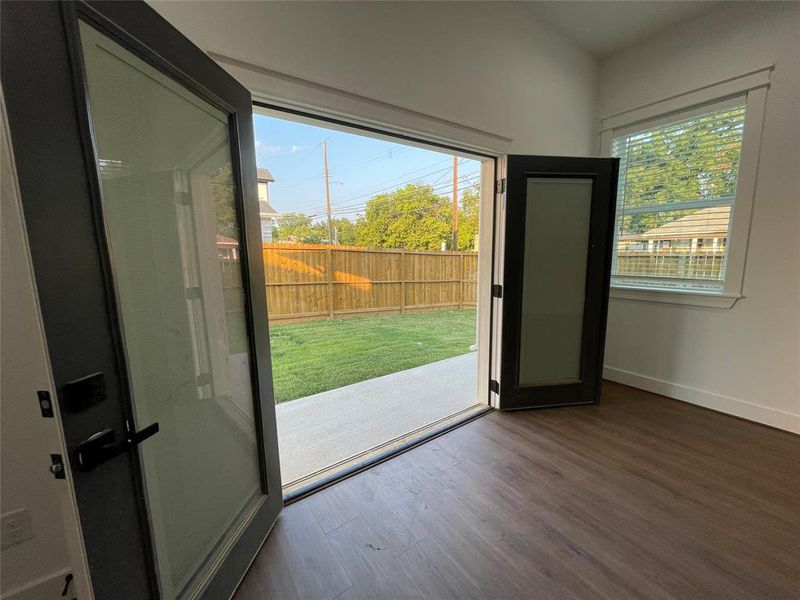 Doorway featuring wood finished floors and baseboards