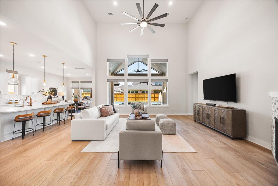 The expansive open-concept living, dining, and kitchen area is designed for effortless entertaining, offering the perfect space for gathering with family and friends while enjoying beautiful views of the backyard oasis.