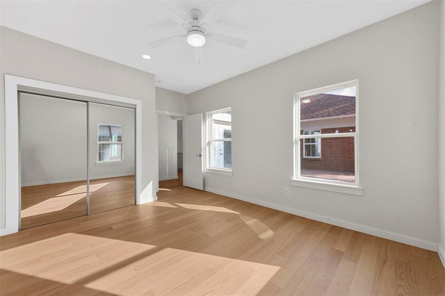 Unfurnished bedroom featuring wood-type flooring, a closet, and ceiling fan