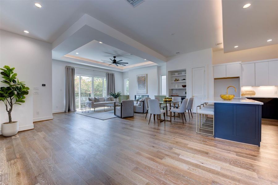 Grand view of second level featuring large island w/seating, dining, and living area.