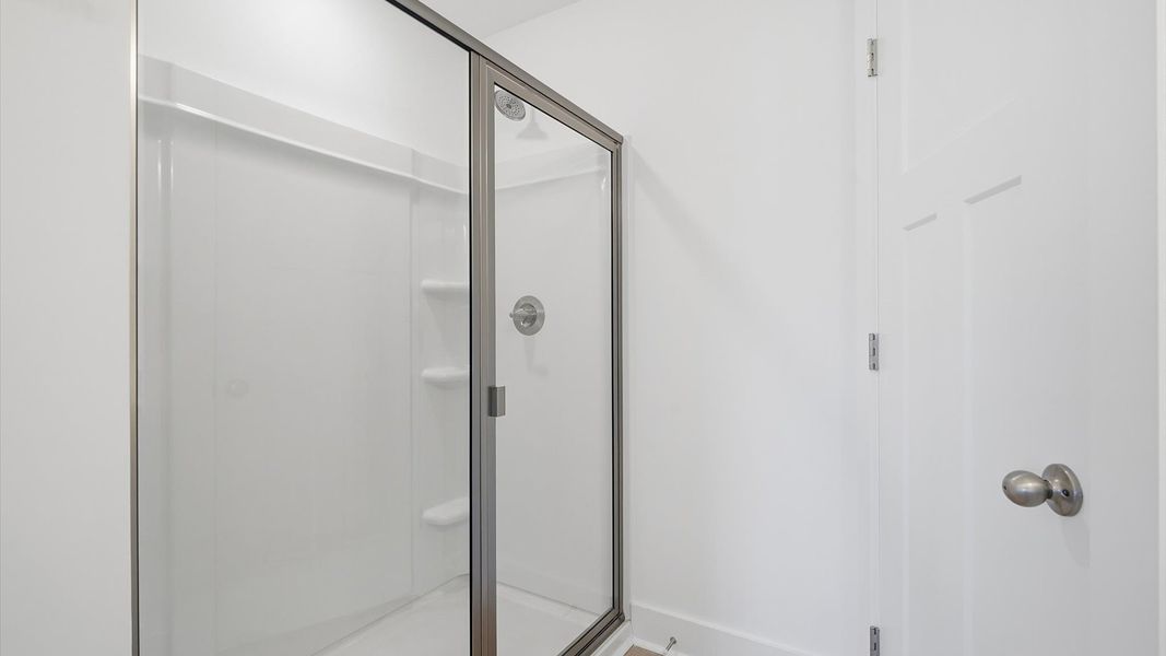 Superior en-suite primary bathroom with a stylish walk-in shower—crafted with high standards in mind Superior en-suite primary bathroom with a stylish walk-in shower—crafted with high standards in mind