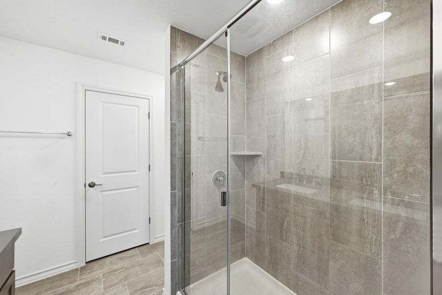 Bathroom with a shower stall and vanity