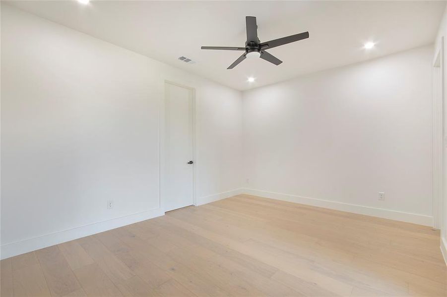 Unfurnished room with light wood finished floors, recessed lighting, and a ceiling fan Unfurnished room with light wood finished floors, recessed lighting, and a ceiling fan
