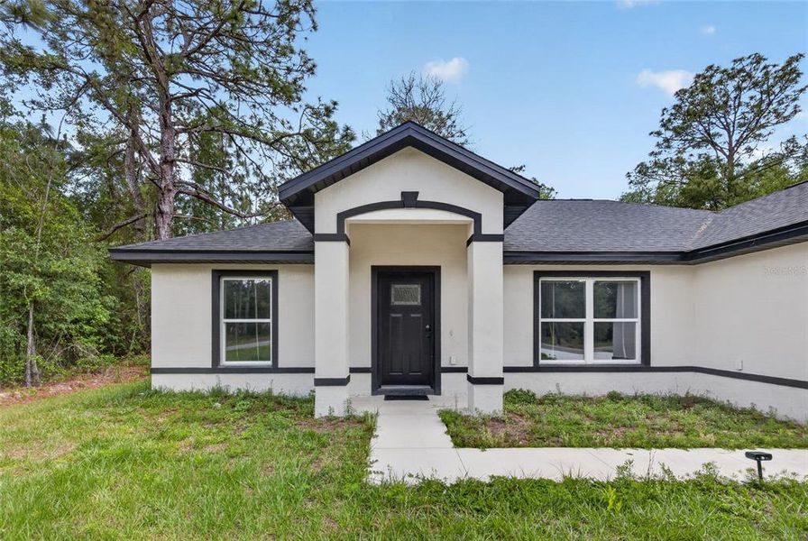 Front exterior of a new home in , Ocklawaha, FL, highlighting curb appeal (Image 23).