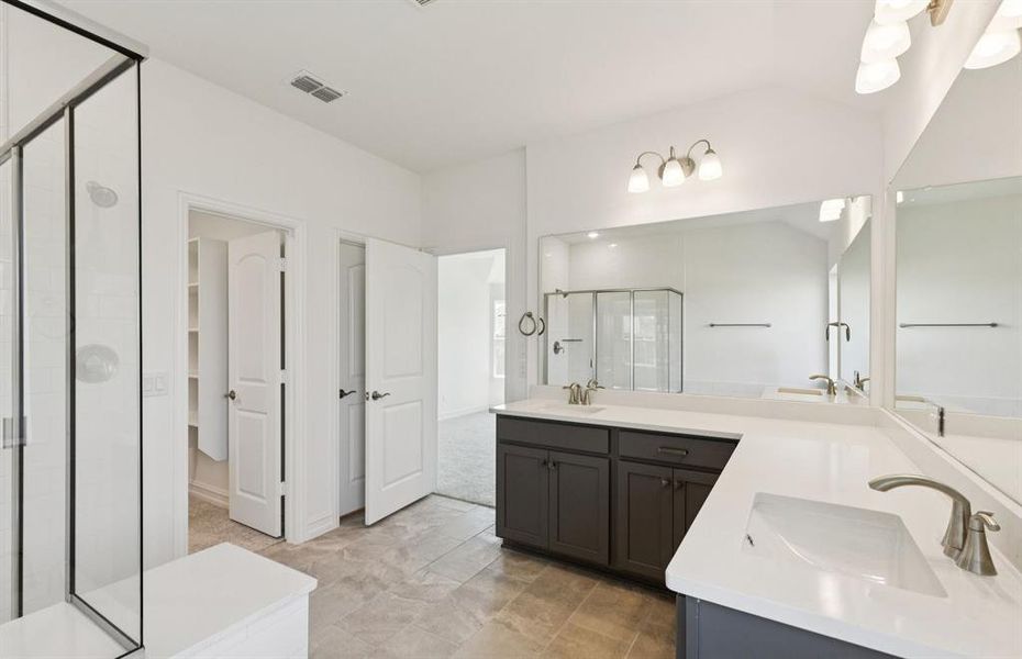 Owner's bath with double vanity and spacious shower *Real home pictured Owner's bath with double vanity and spacious shower *Real home pictured