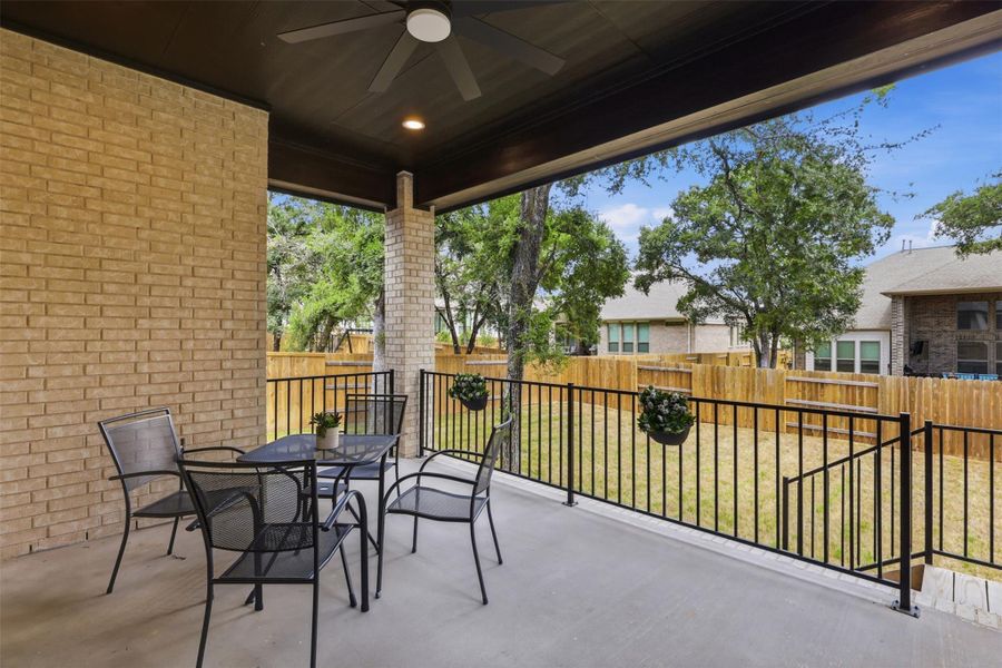 A generous covered patio extends outdoor living into a privately fenced yard.