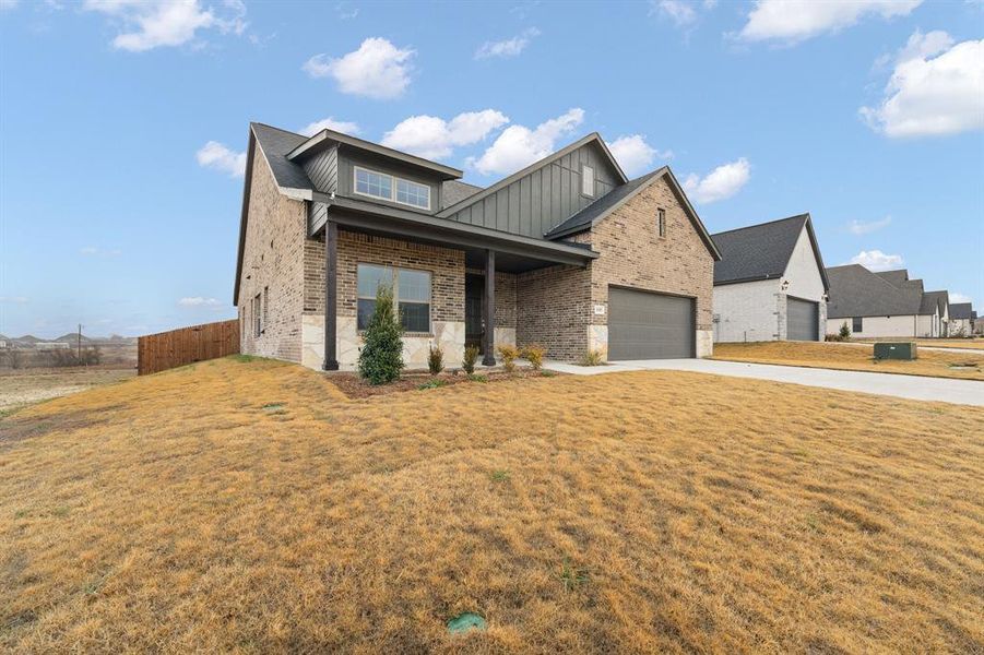 Front exterior of a new home in , Venus, TX, highlighting curb appeal (Image 17).