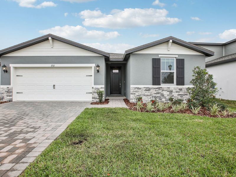 Front exterior of a new home in Two Rivers - Classic Series, Zephyrhills, FL, highlighting curb appeal (Image 1). Front exterior of a new home in Two Rivers - Classic Series, Zephyrhills, FL, highlighting curb appeal (Image 1).