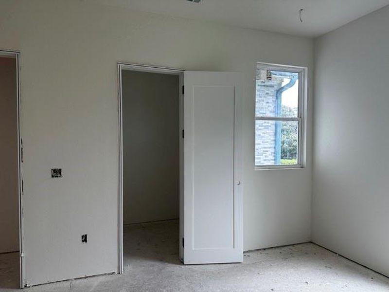 Unfurnished bedroom featuring a walk in closet
