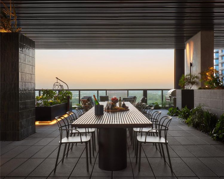 An covered outdoor dining terrace showcases a slatted ceiling and panoramic horizon views. An covered outdoor dining terrace showcases a slatted ceiling and panoramic horizon views.