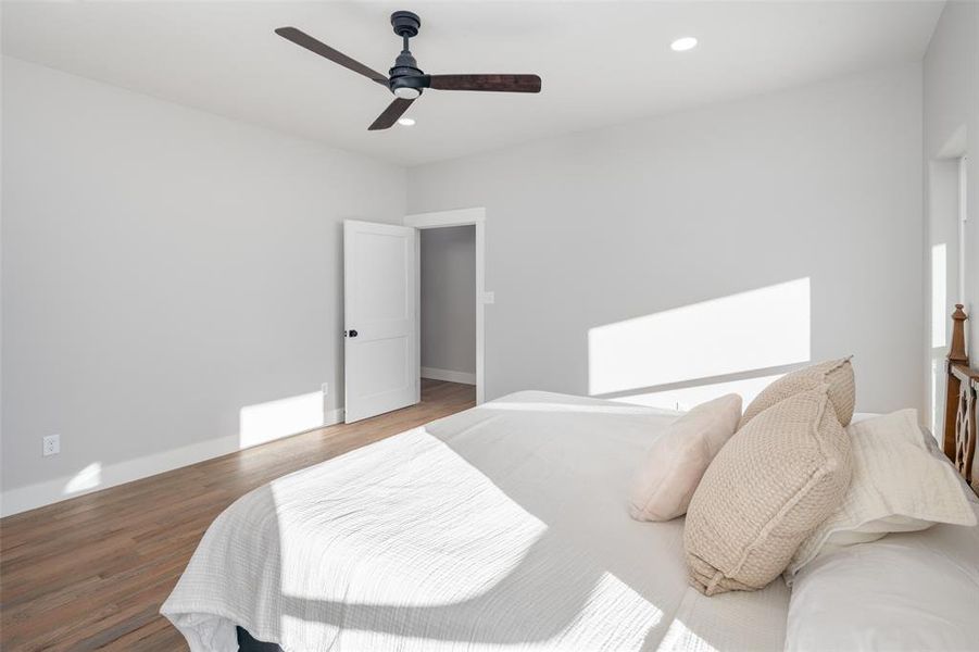 Bedroom with hardwood / wood-style floors and ceiling fan